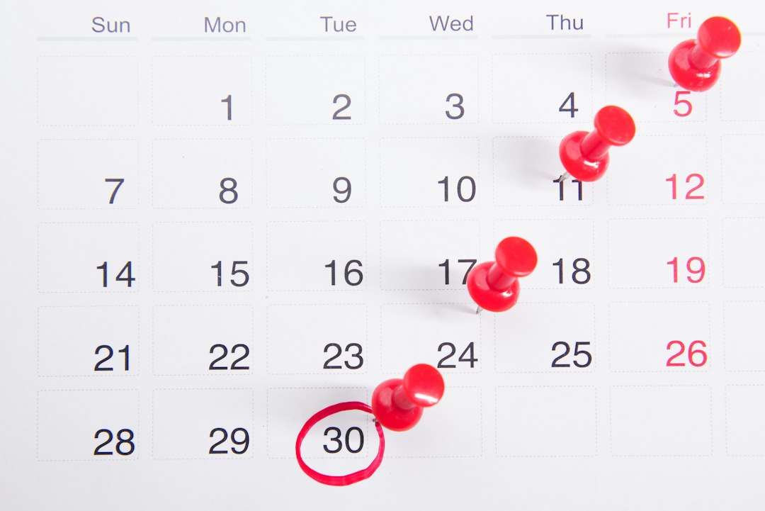 Calendar page with red push pins marking the dates